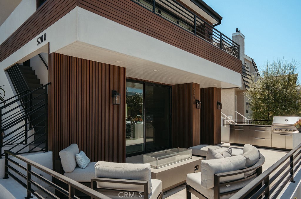 Turfed upper entertainment deck with lounge seating at 520 Iris Ave