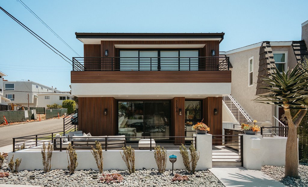 Front elevation of 520 Iris Ave, a remodeled corner duplex in the Corona del Mar Village