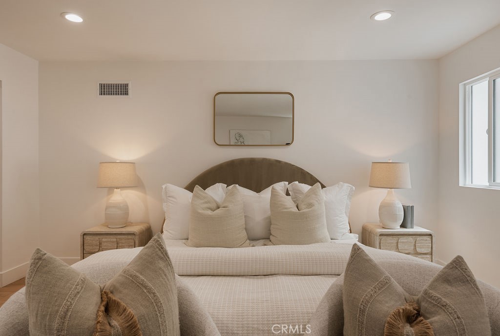 Primary bedroom with vaulted ceiling