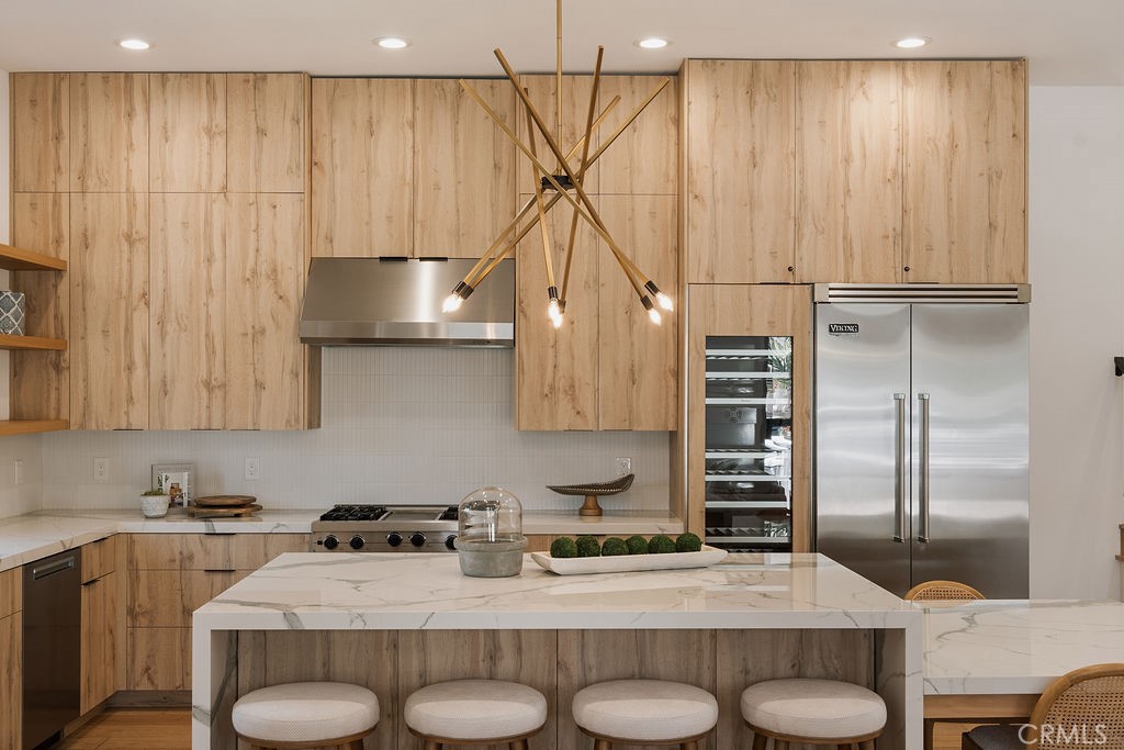 Upper unit kitchen with white oak cabinetry and stone island at 520 Iris Ave